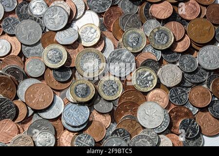 British metric coins on a table with 1p, 2p, 5p, 10p 20p, 50p, £1 and £2 coins included Stock Photo