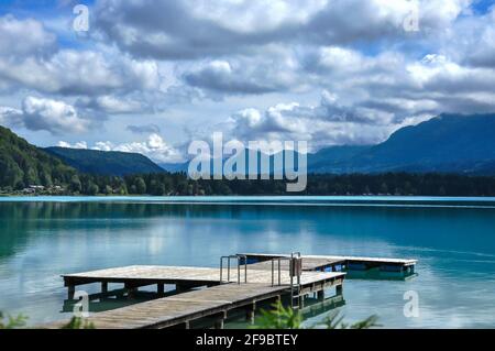 Fantastically beautiful mountain lake, with a jetty that protrudes into the water and a mountain panorama in the background