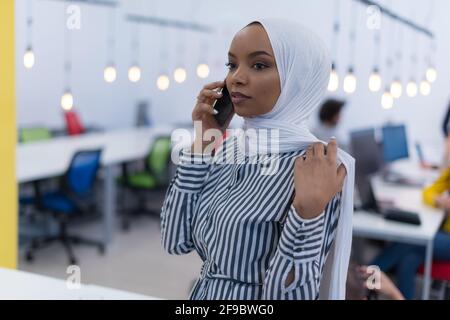 Beautiful african corporate worker talking on mobile phone. Happy african american career woman using cell phone Stock Photo
