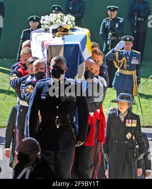 Pall Bearers carrying the coffin of the Duke of Edinburgh, followed by Princess Anne (right) entering St George's Chapel, Windsor Castle, Berkshire. Picture date: Saturday April 17, 2021. Stock Photo