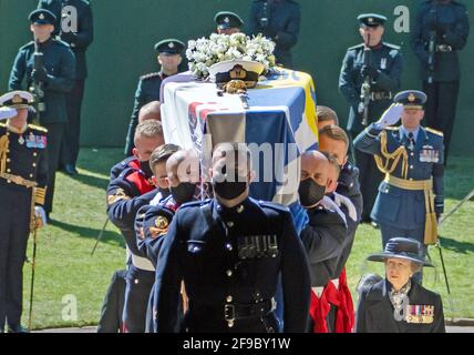 Pall Bearers carrying the coffin of the Duke of Edinburgh, followed by Princess Anne (right) entering St George's Chapel, Windsor Castle, Berkshire. Picture date: Saturday April 17, 2021. Stock Photo