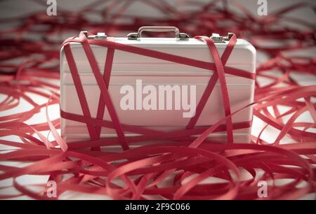 Red tape around a briefcase labeled tax Stock Photo