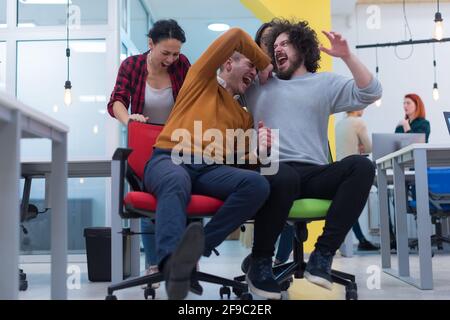 Group of  Creative office workers collaborate together making joke with each other during their work inside office. succes and competition business co Stock Photo