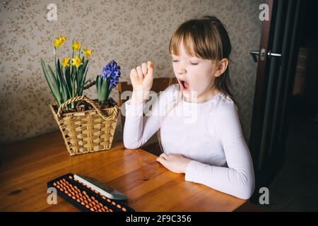 girl learning to count on abacus Stock Photo