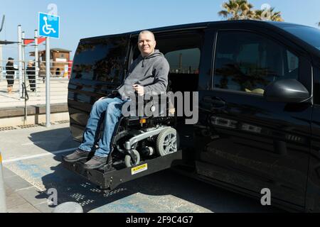 Disabled man on wheelchair car lift Stock Photo