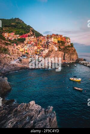 Manarola village on cliff rocks and sea at sunset., Seascape in Five lands, Cinque Terre National Park, Liguria Italy Europe. Stock Photo