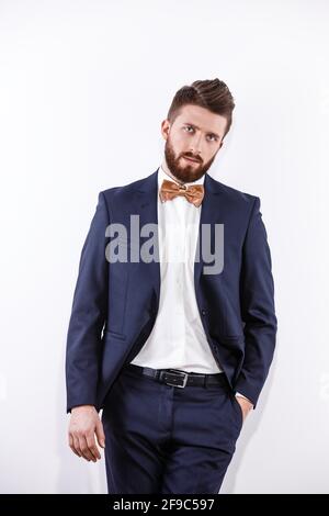 Elegant young handsome man in black classic costume. Studio fashion portrait. Stock Photo