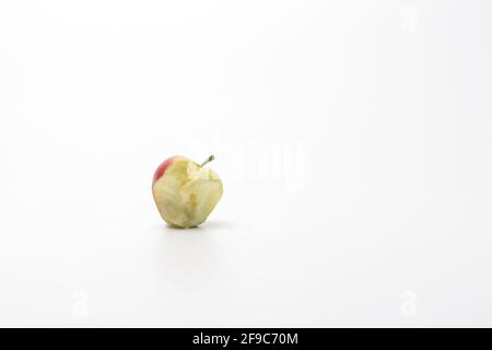 Red delicious bitten apple isolated on white. An apple stub. Stock Photo