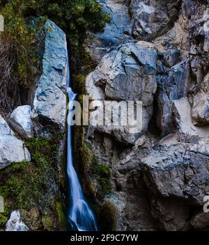 a large waterfall over a rocky cliff Stock Photo