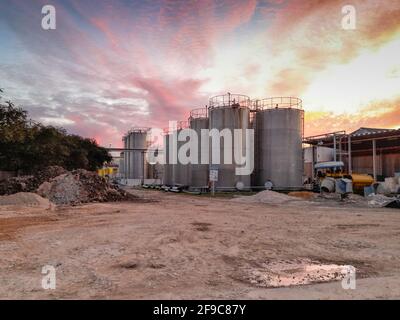 Large metal silo for storing raw material. Modern industrial plant Stock Photo