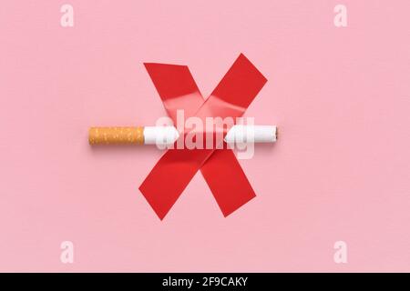 A cigarette crossed out with a cross, a red sign No smoking. Stock Photo