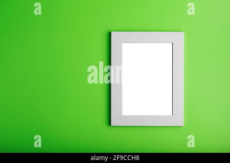 White photo frame on green background with free space. Minimalistic concept Stock Photo