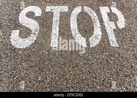 STOP a large inscription on the asphalt in full screen. Stock Photo