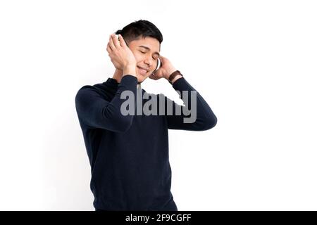 Caucasian man with headphones listening to music isolated on a white background Stock Photo