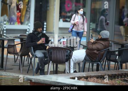 Sofia, Bulgaria - Apr 4 2021: Two men drinking coffee outside Stock Photo