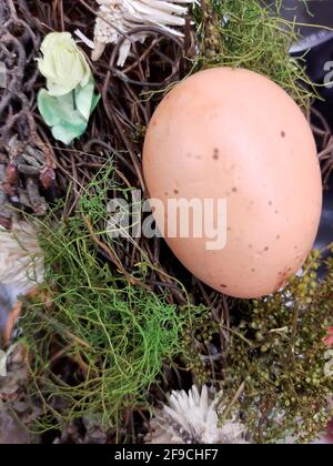 On the eve of Easter, festive decorations in the form of colorful Easter eggs and decorative greenery. Stock Photo