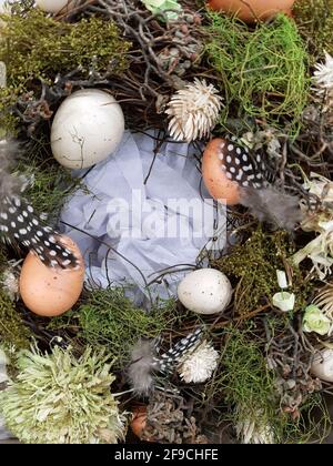 On the eve of Easter, festive decorations in the form of colorful Easter eggs and decorative greenery. Stock Photo