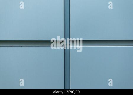 Cross-shaped metal cladding panels on the building wall Stock Photo