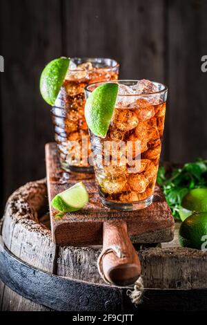 Sweet iced tea with lime and ice. Drink for summer heat. Long Island Iced Tea. Stock Photo