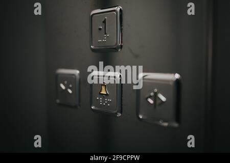 Closeup of elevator metal buttons - "-1", "open door", "alert", and "close door" Stock Photo