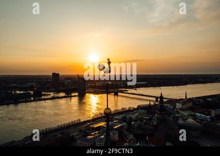 Riga cityscape at sunset with reflection in Daugava river, Latvia Stock Photo