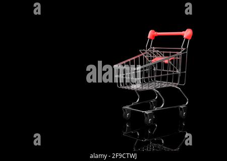 Supermarket trolley close-up on a black background. Copy space. 3D rendering. Stock Photo