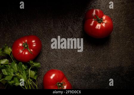 Tomatoes on wooden brown table. Overhead shot Stock Photo