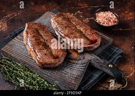 BBQ roasted Shoulder Top Blade cut or Australia wagyu oyster blade beef steak. Dark background. Top View Stock Photo