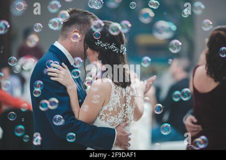 Newlywed couple having their first dance with bubbles in the reception Stock Photo
