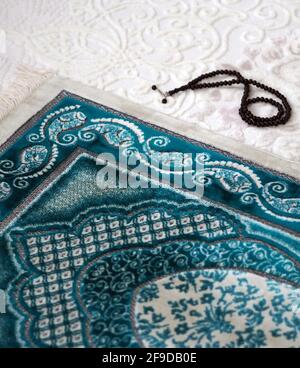 Prayer rug and rosary for worshiping in the month of Ramadan, Stock Photo