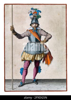 A full-length soldier holding a spear (lance) upright with his right hand Stock Photo