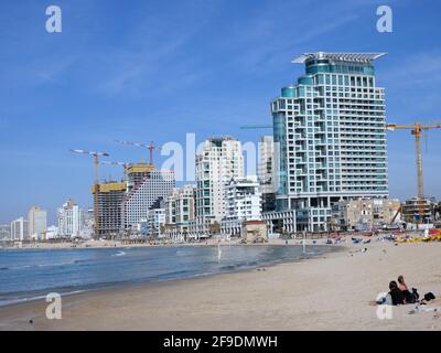 Tel Aviv, Israel - January 17, 2017:  Tel Aviv's waterfront has a sandy beach and modern high rise hotels and apartment buildings Stock Photo