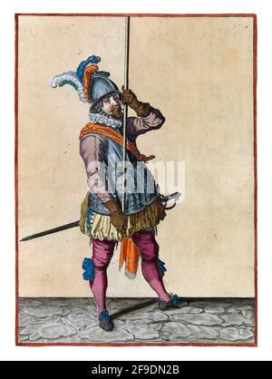 A soldier, full-length, to the right, holding a spear (lance) with both hands upright in front of him high above the ground. This is the first operati Stock Photo