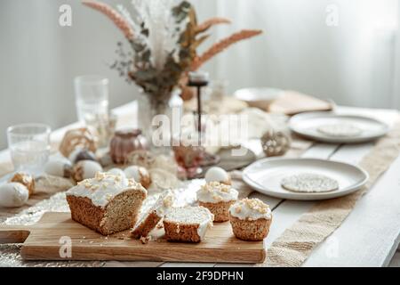A festive table with a beautiful setting and freshly baked Easter cake. Stock Photo