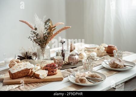 A festive table with a beautiful setting and freshly baked Easter pastries. Stock Photo