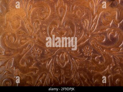 brown leather book or journal cover with a decorative floral ornament. Stock Photo