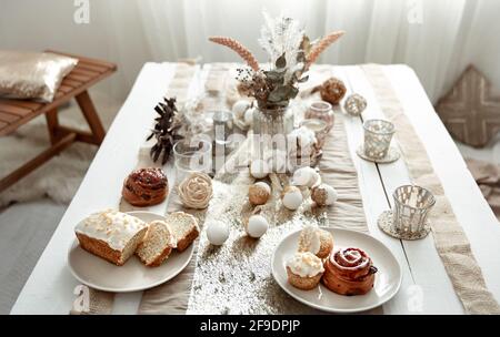 Stylish table setting for the celebration of Easter. Easter fresh baked goods. Stock Photo