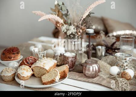Freshly baked homemade cakes on a festive Easter table. Home serving hygge style. Stock Photo