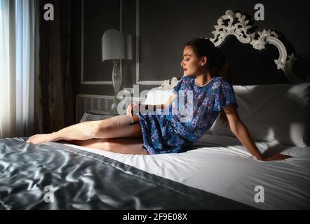 A girl is wearing a pair of shiny stockings Stock Photo