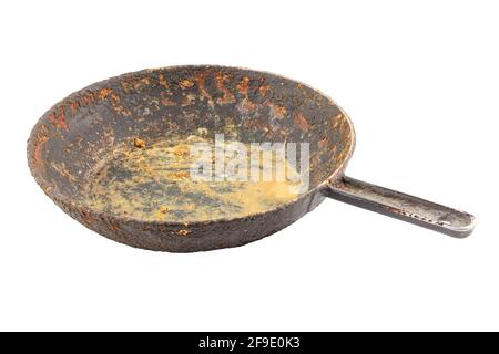 old disgusting stained rusty cast iron pan with burnt fat and food leftovers isolated on white background Stock Photo