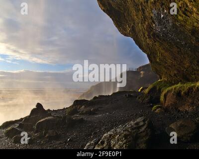 View of beautiful small cave behind famous waterfall Seljalandsfoss, a popular tourist destination located near ring road in southern Iceland. Stock Photo