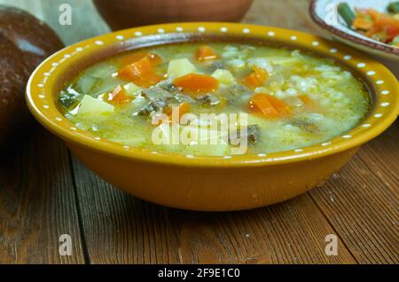 Krupnik zupa -  thick Polish soup made from vegetable or meat broth, containing potatoes and barley groats Stock Photo