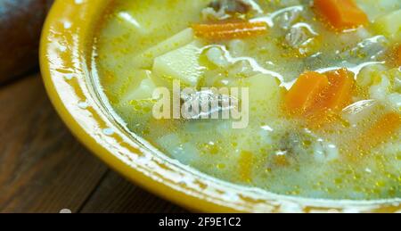 Krupnik zupa -  thick Polish soup made from vegetable or meat broth, containing potatoes and barley groats Stock Photo