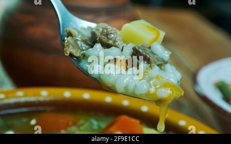 Krupnik zupa -  thick Polish soup made from vegetable or meat broth, containing potatoes and barley groats Stock Photo