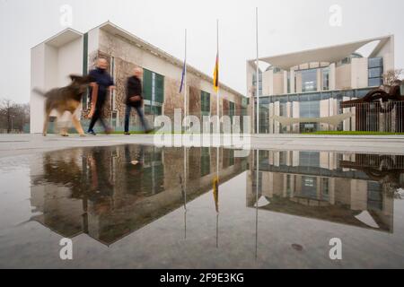 Berlin, Germany. 18th Apr, 2021. The flags at the Federal Chancellery hang at half-mast on the occasion of the central commemoration for those who died in the Corona pandemic in Germany. Credit: Christoph Soeder/dpa/Alamy Live News Stock Photo