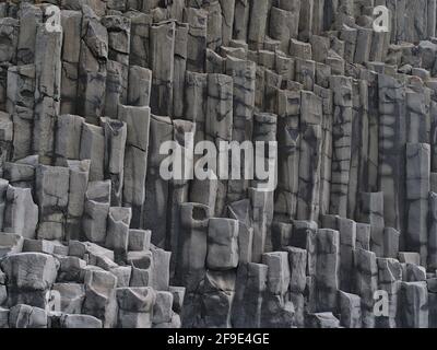 Closeup view of volcanic basalt columns on the famous Reynisfjara beach, a popular tourist destination in the south of Iceland. Stock Photo