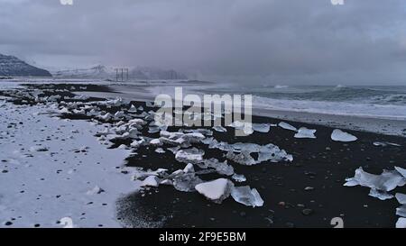 Beautiful view of rough diamond beach with black sand and small icebergs on the southern coast of Iceland near Jökulsárlón and ring road. Stock Photo