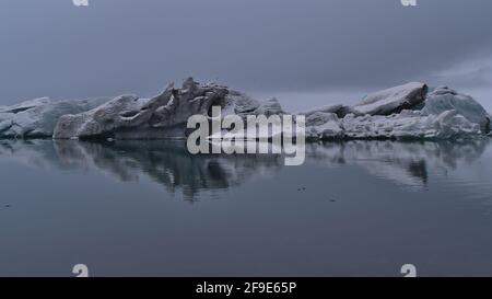 View of floating icebergs with bizarre ice formations on famous glacier lagoon Jökulsárlón, located in Vatnajökull national park in southern Iceland. Stock Photo