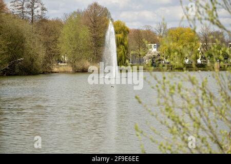 Fountain in a lake surrounded by tress near Oss, Netherlands Stock Photo