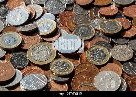 British metric coins on a table with 1p, 2p, 5p, 10p 20p, 50p, £1 and £2 coins included. A Diversity Built Britain 50 pence piece central- Stock Photo